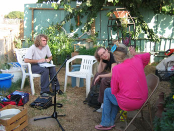 Photograph of Jo & Ryan talking to Evonne in her front yard